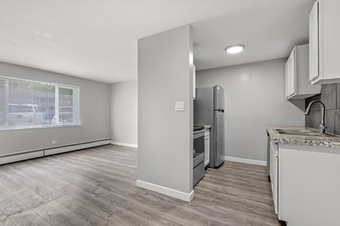 A kitchen with a refrigerator, oven, and countertop.